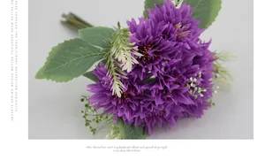 Detail of purple artificial daisy bouquet with green leaves and delicate white filler flowers