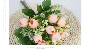 Detail of pink silk rosebuds bouquet on woven mat for wedding and home decoration