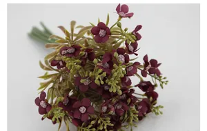 Detailed close-up of burgundy artificial hydrangea bundle with green leaves and realistic buds