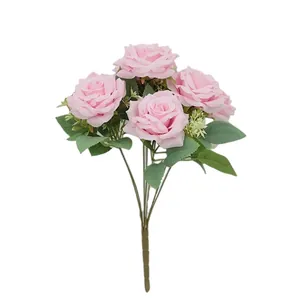 Artificial pink Austin roses bouquet with green leaves and small white flowers on white background