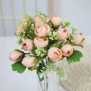 Artificial peach tea rose bouquet in a glass vase for home decor and wedding setting