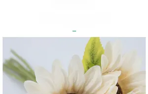 Detail of cream white silk sunflowers showing realistic petal texture and green leaves