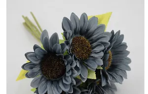 Macro detail of artificial sunflower with grey-blue petals and realistic fuzzy center