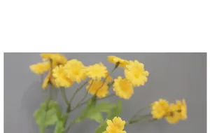 Close-up of yellow silk chamomile flowers with green stems for home wedding decor