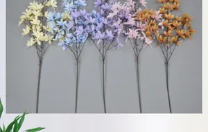 Detail of five artificial lily branches in assorted soft colors for wedding decoration