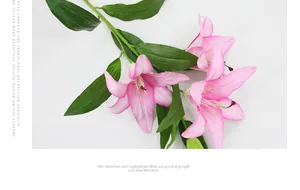 Close-up of artificial pink lily with 3D printed petals and realistic green leaves detail
