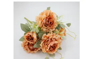Close-up of vintage apricot artificial peony bouquet with realistic layered petals