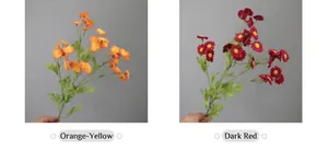 Close-up of artificial chamomile and daisy silk flowers in orange and deep red tones