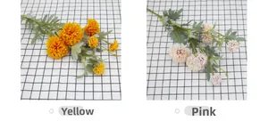 Detailed view of artificial dandelion and chrysanthemum bouquets in yellow and pink shades