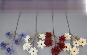 Detailed view of artificial dahlia silk flowers in red, cream and blue for wedding decor
