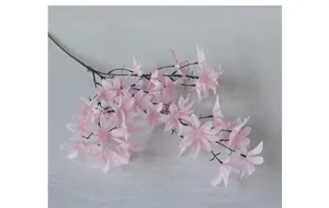 Macro detail of artificial pink silk orchids with gradient petals and realistic stems
