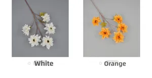 Detail view of artificial dahlia flowers in white and orange with five heads