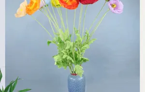 Vibrant multicolored artificial poppy bouquet in a blue textured vase for home decor