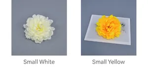 Close-up of small white and yellow artificial peony flower heads for DIY crafts