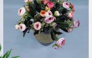 Top view of multi-color artificial camellia bouquet in a spiral grey ceramic vase