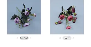 Detail of faux camellia and rose bundles in deep purple and vibrant red for weddings