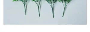 Detalle de cuatro tallos de eucalipto artificial con follaje de plástico verde muy realista