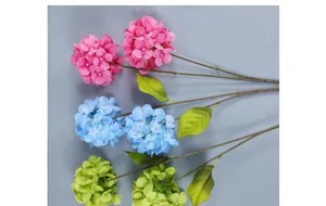 Detailed view of artificial hydrangea flowers in pink, blue, and green for wedding decor