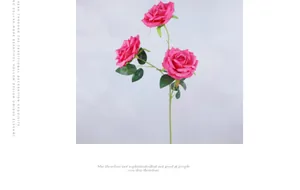Close-up of artificial pink rose with three heads and realistic green leaves for wedding decor