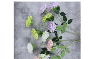 Detailed overhead view of multicolored faux roses with textured petals and green leaves