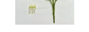 Close-up of artificial white calla lily stamen and green plastic stem component detail
