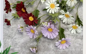Close-up of multicolored artificial daisies in red, white and purple with realistic petals