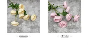 Detail view of champagne and pink artificial camellia flowers with layered petals