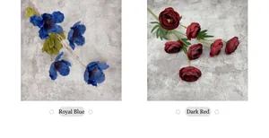 Detailed comparison of royal blue and dark red artificial camellia flowers with green leaves