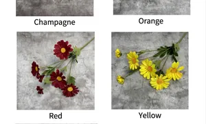 Detailansicht künstlicher Gänseblümchen in Rot, Gelb, Orange und Champagnerfarben