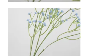 Macro detail of artificial blue gypsophila flowers with realistic green branch stems