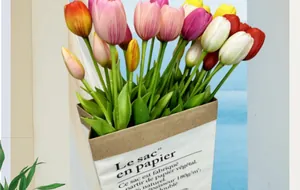 Detail of colorful artificial tulips in a white decorative paper bag for home decor