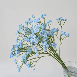 Faux blue gypsophila bouquet in glass vase for elegant home floral decoration