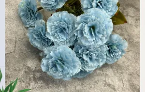 Detail shot of pale blue artificial carnation petals with rich textures on cement