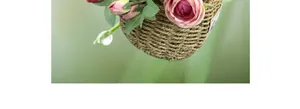 Close-up of artificial roses in a woven basket with detailed petal textures and leaves
