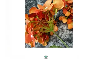 Macro detail of artificial orange hydrangea with realistic fabric texture and green stem