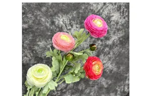Detailed view of artificial Ranunculus flowers with colorful petals and flocked green leaves
