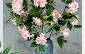 Detailed view of pink silk hydrangea bouquet in a blue textured ceramic vase