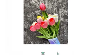 Close-up of colorful artificial PU tulips in a colorful iridescent glass vase