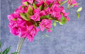 Detail of vibrant rose pink artificial bougainvillea with realistic leaves and stems