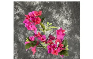 Macro detail of deep pink silk bougainvillea flowers with green leaves and realistic stems