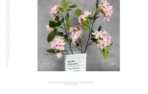 Detailed view of artificial pink and white gradient hydrangea flowers in a ceramic vase