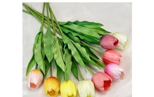 Detail of 9 realistic PU tulips in various colors on white textured fabric background