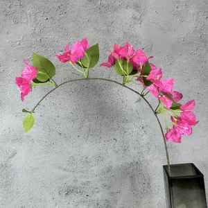 Vibrant pink artificial bougainvillea branch in a glass vase for home decor