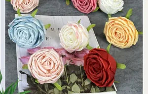 Detailed view of assorted colorful artificial silk rose heads for wedding DIY decor