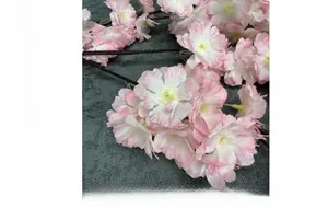 Detailed view of artificial cherry blossoms with pink and white gradient silk petals