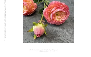 Detail van roze-oranje kunstmatige rozen met gelaagde bloembladen en kleine bloemknop
