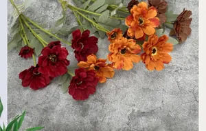 Detailed close-up of multi-head artificial cosmos flowers with burgundy and orange petals
