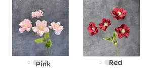 Detail shot of artificial anemone flowers in pink and red with realistic green leaves