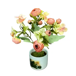 Pink artificial rose bouquet in a blue ceramic landscape pot for home decor
