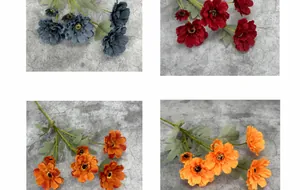 Detail view of colorful silk zinnias in fog blue and red for wedding home decor